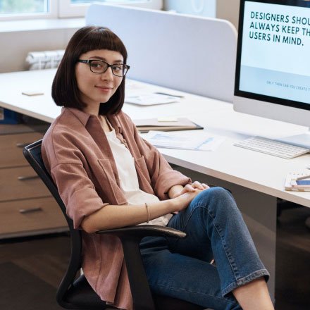 Woman Sitting on Chair at a Desk Woman Sitting on Chair at a Desk